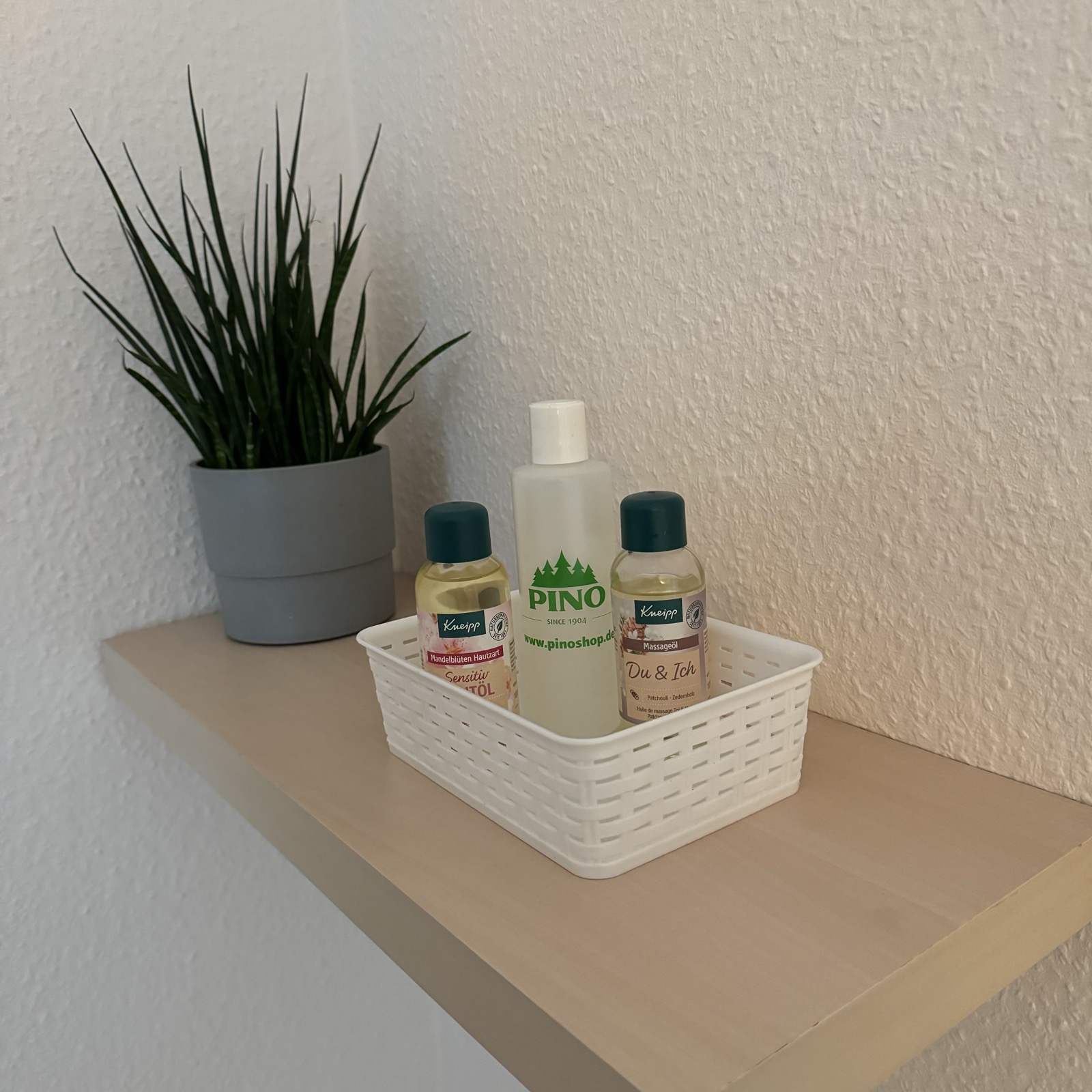 Ablage mit Massageölen und Pflanze